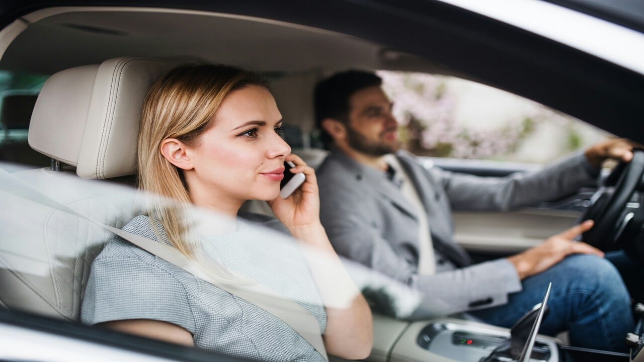 A man driving his wife to work