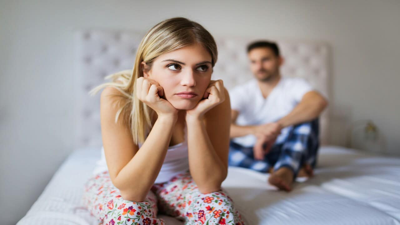 A man looking at his upset wife