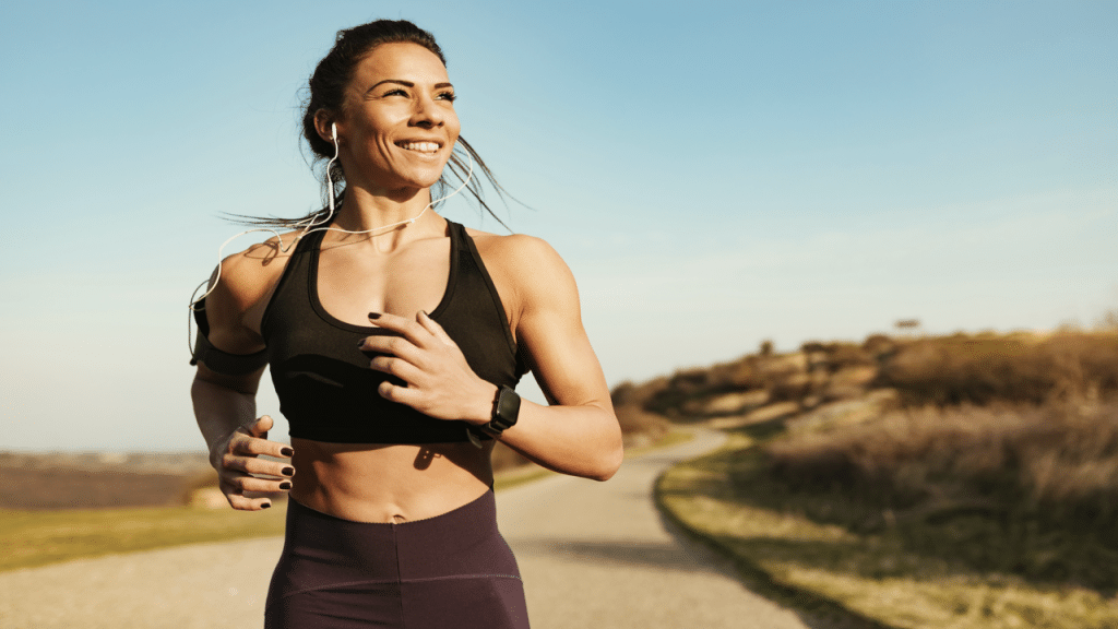 A woman smiling while jogging