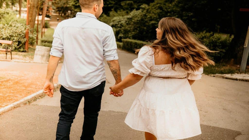 couple holding hands during walk