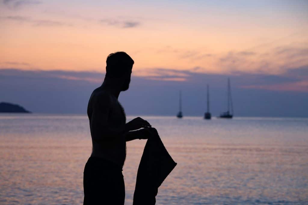 man reflective sunset