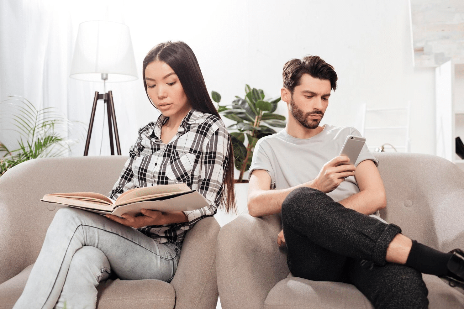 A man and woman busy with their own hobbies