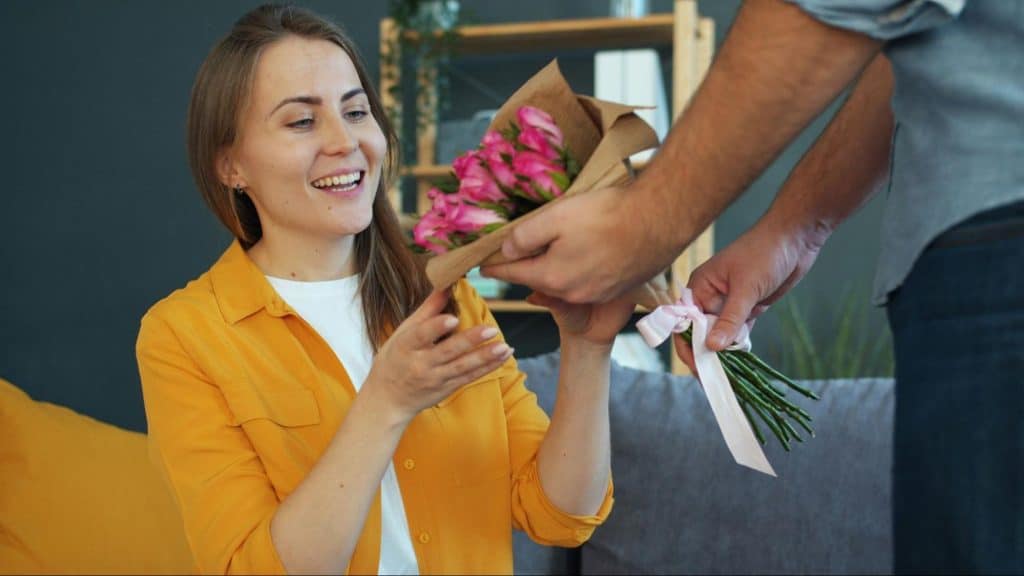 Woman receiving a flower from a man