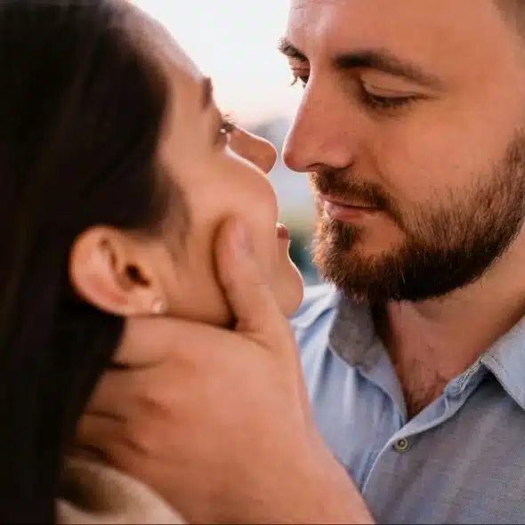 A man holding a woman’s face