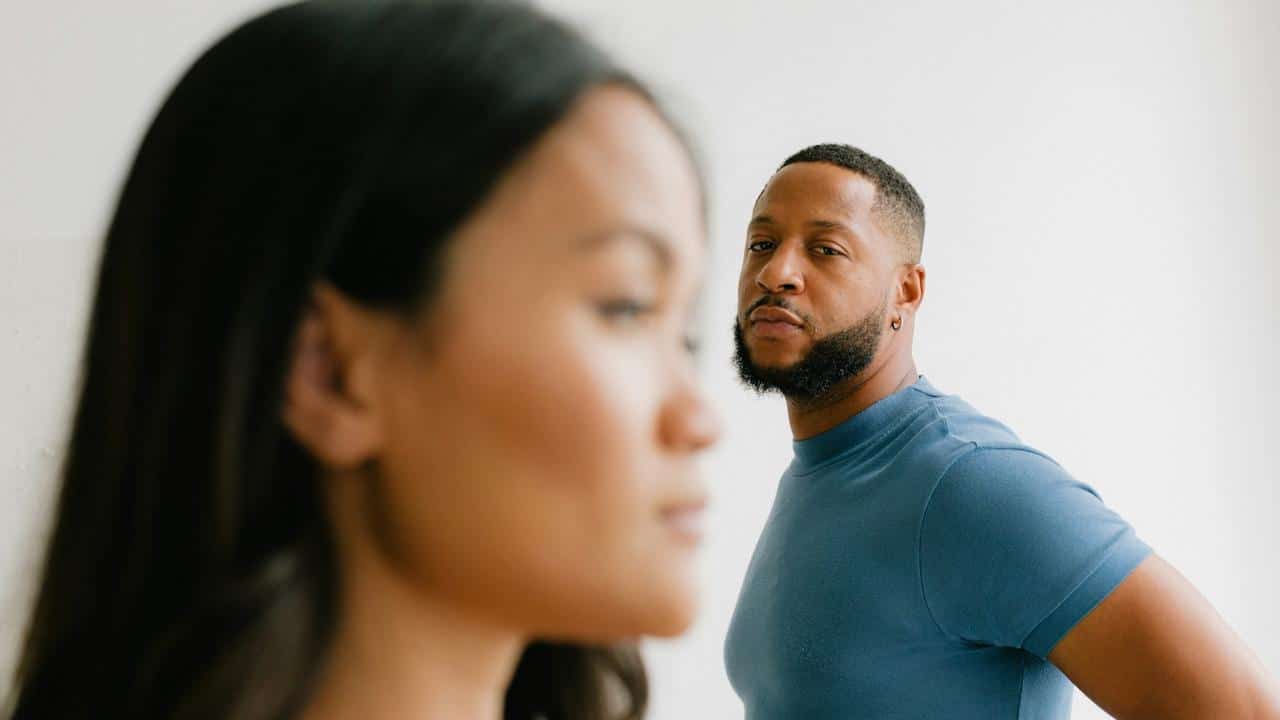 A bearded man looking at a woman.