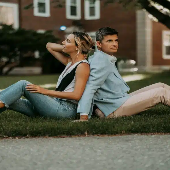 couple sitting together but looking disengaged