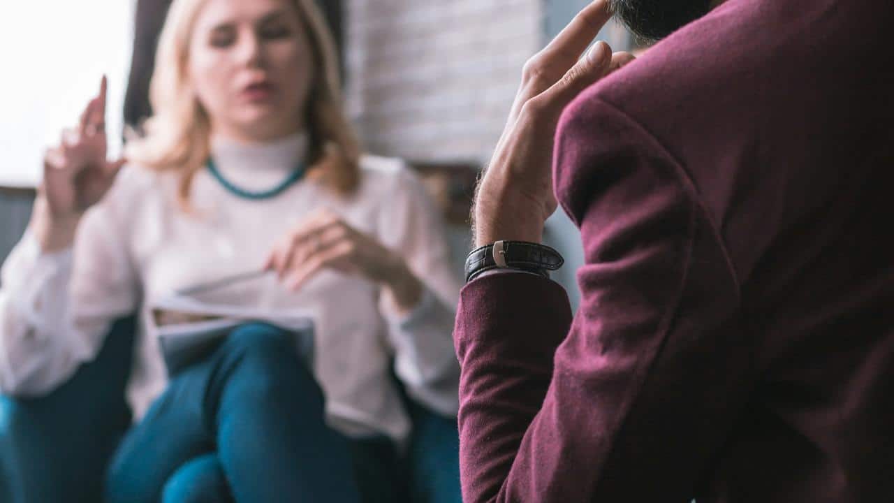 A woman talking with a man