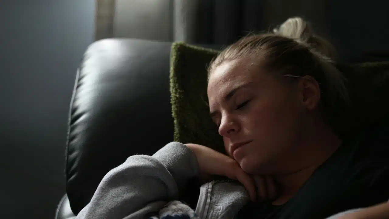 A woman sleeping peacefully on a couch