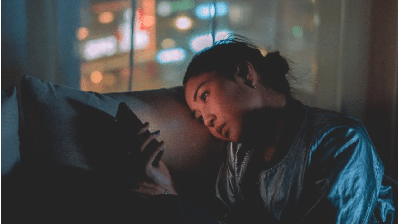 A woman looking sad while texting