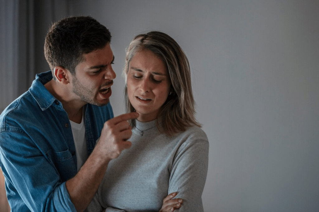 Man screaming at woman in their home