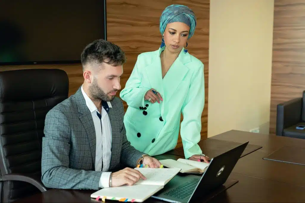 A confident man and a woman beside him