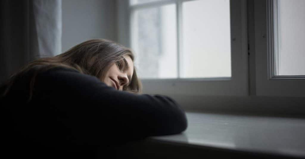 A person rests their head on a table
