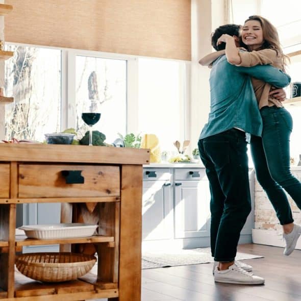 A couple hugging in the kitchen