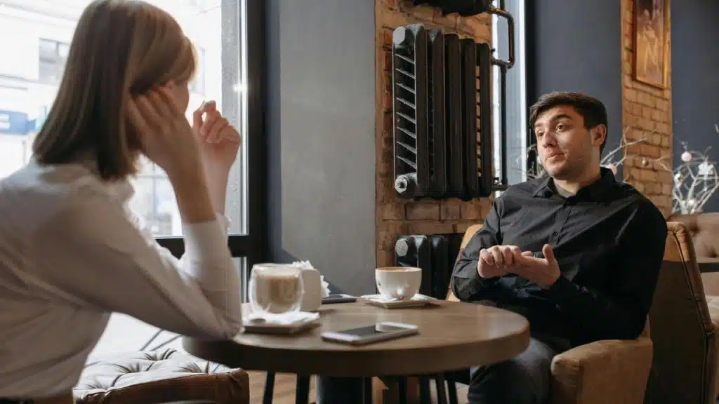 A man and woman talking over coffee 
