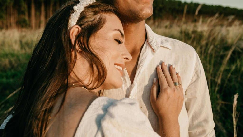 A woman resting her head on a man’s chest