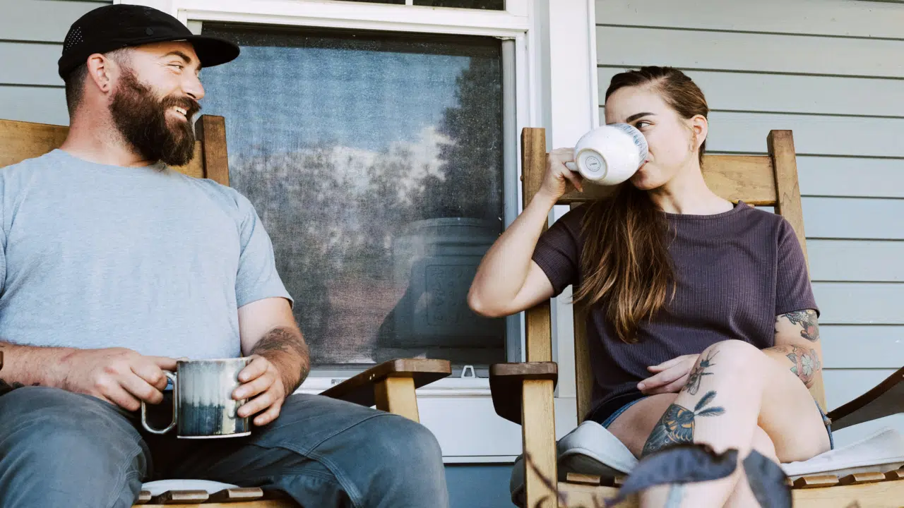 A couple talking on the porch