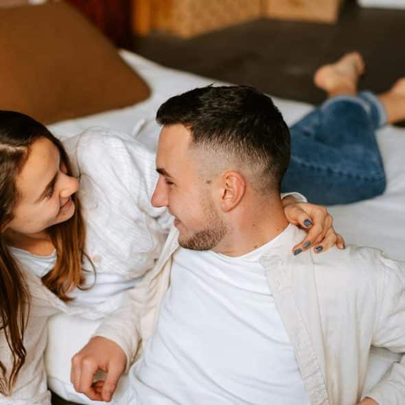 A couple lying on a bed