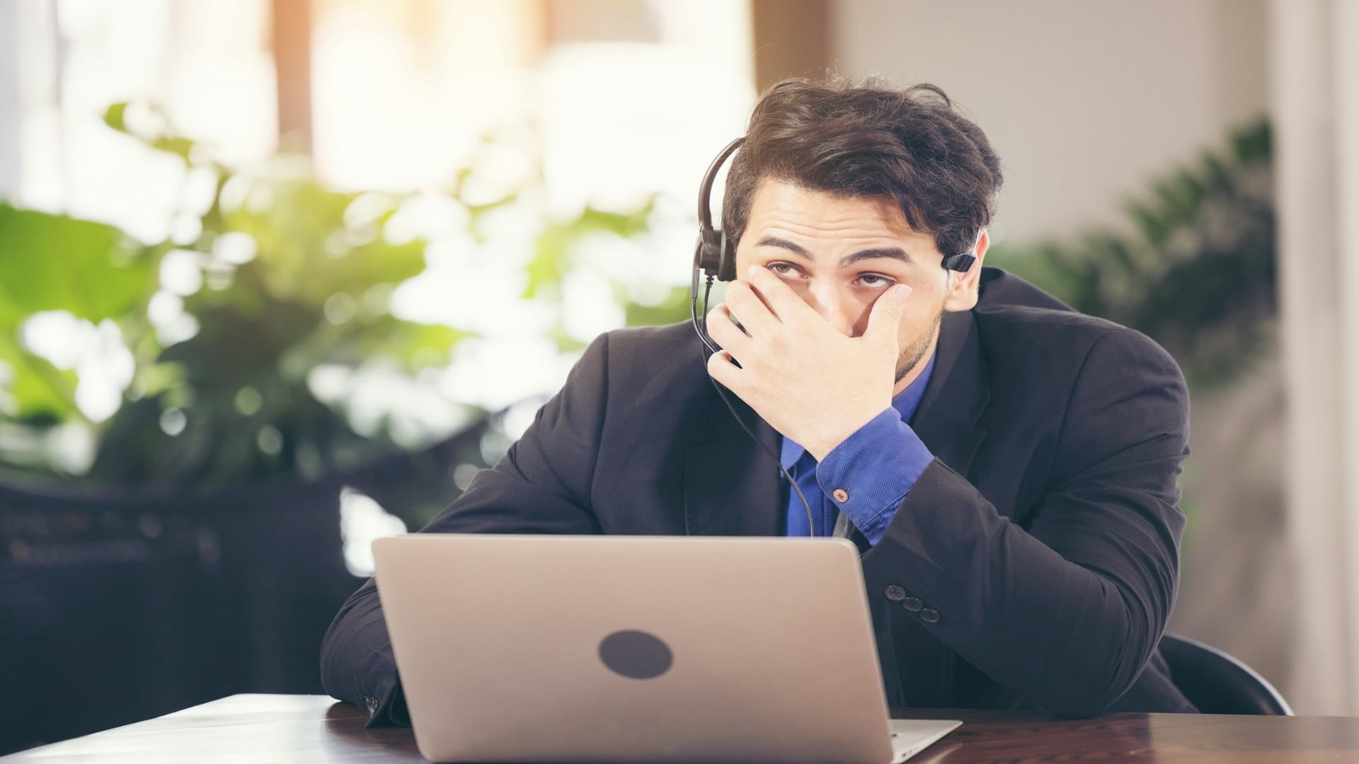 man looking stressed at desk