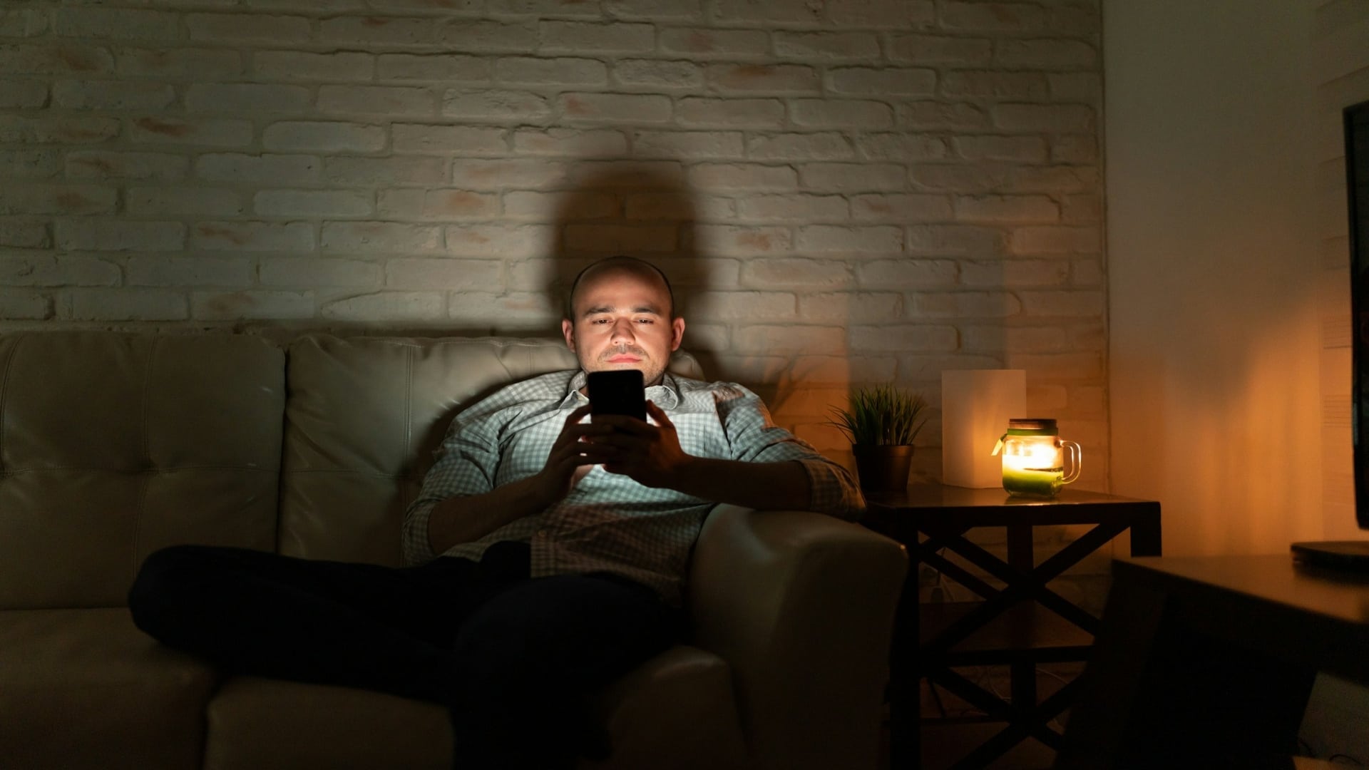 man scrolling phone alone
