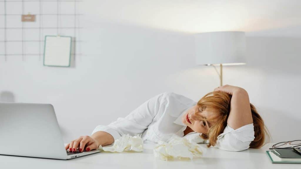 A bored woman looking at her laptop