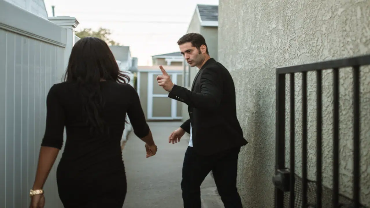 A couple fighting outside their home