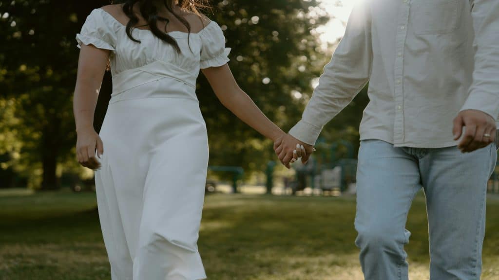 couple holding hands while walking