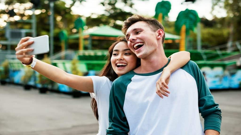 Young couple having fun together at an amusement park