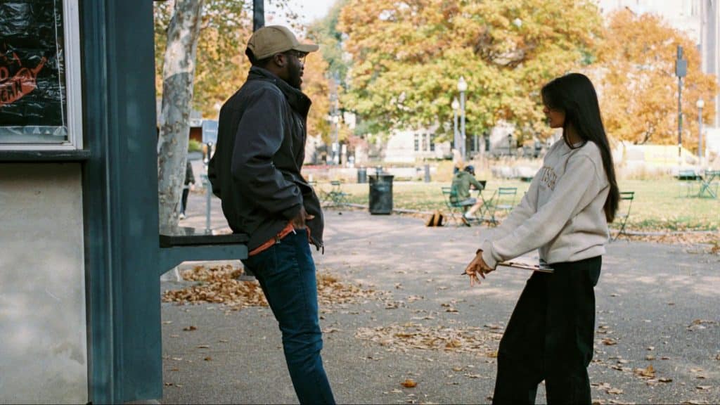 A man and woman having a conversation outside