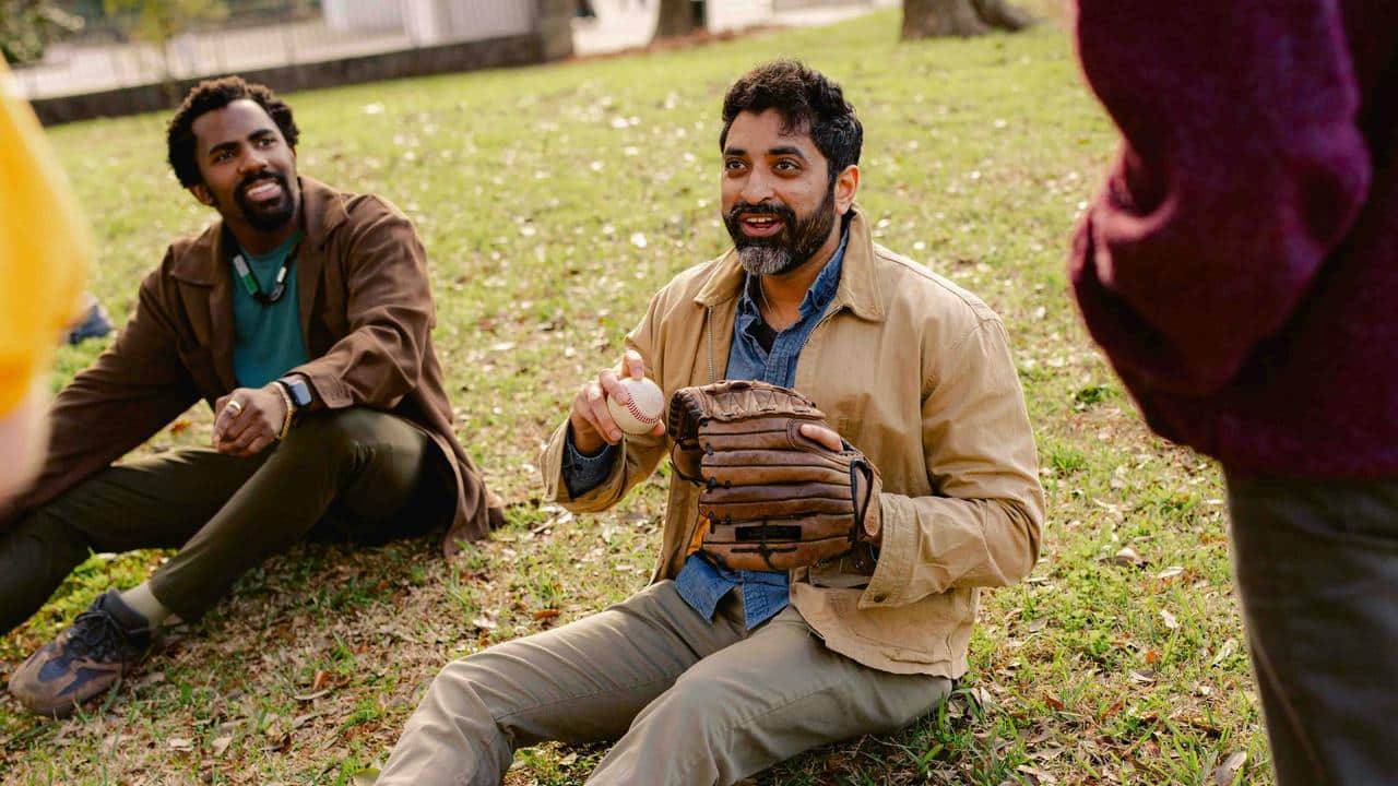 A man holding a baseball and a glove