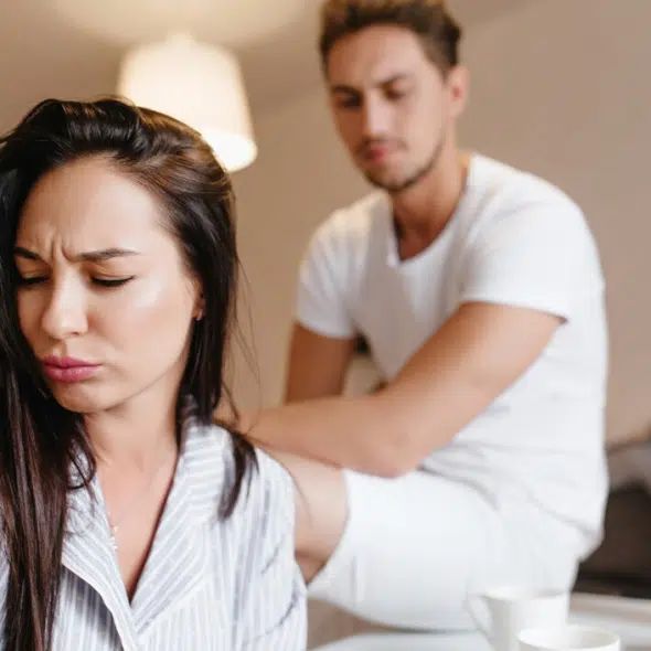 Upset woman turned away from her boyfriend
