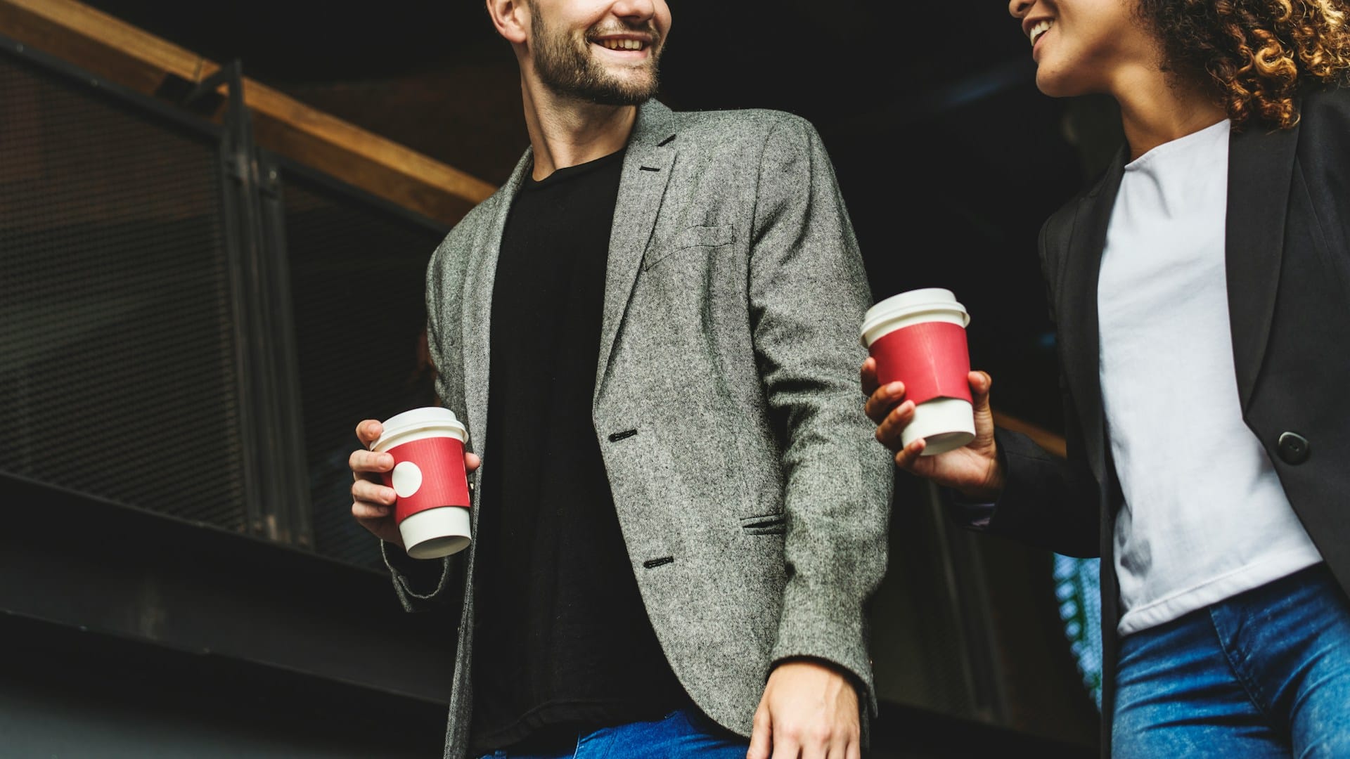 man bringing coffee to partner