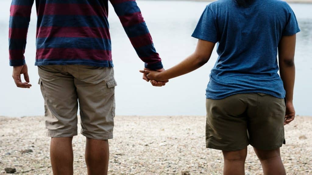 couple holding hands outdoors