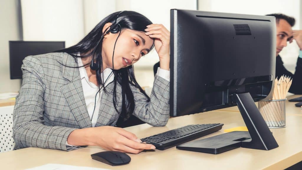 woman looking stressed at desk