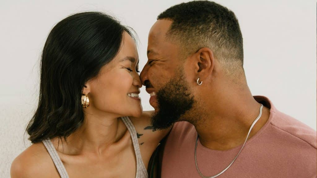A man and a woman smiling at each other.