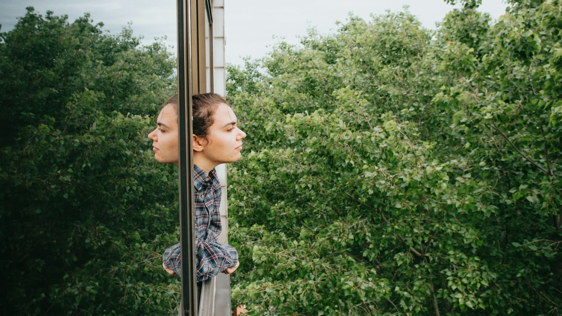 individual reflecting thoughtfully outdoors