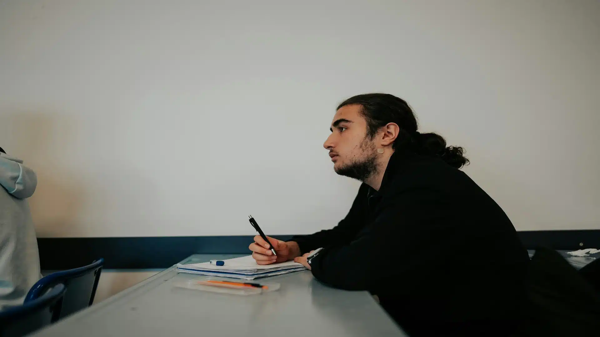 man looking thoughtful by window