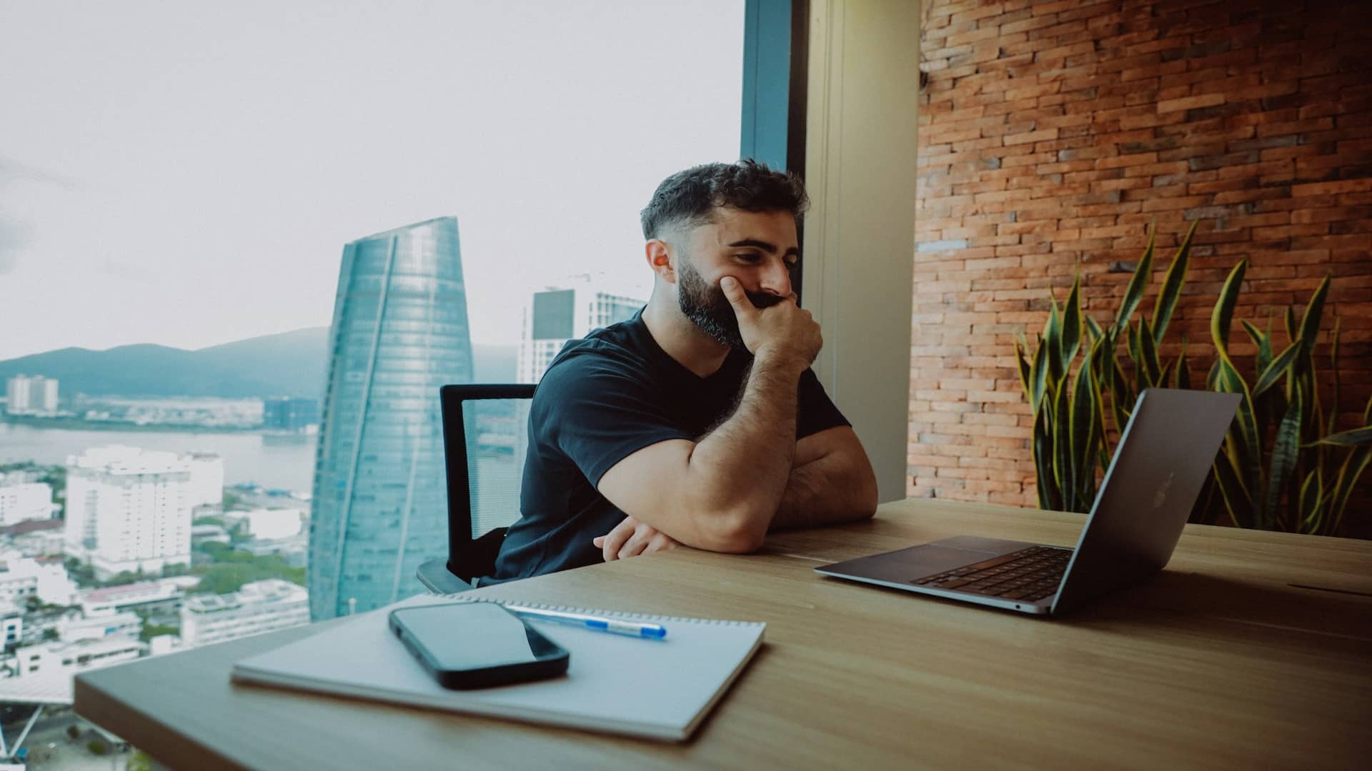 man sitting thoughtfully at desk