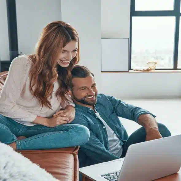 A couple smiling while spending time at home