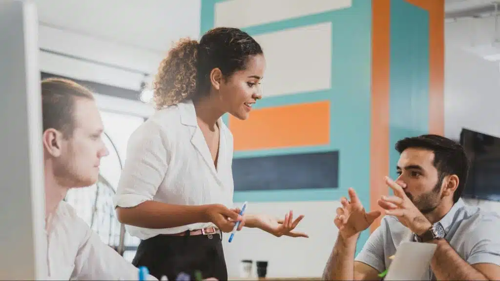 A man and woman arguing in front of other person