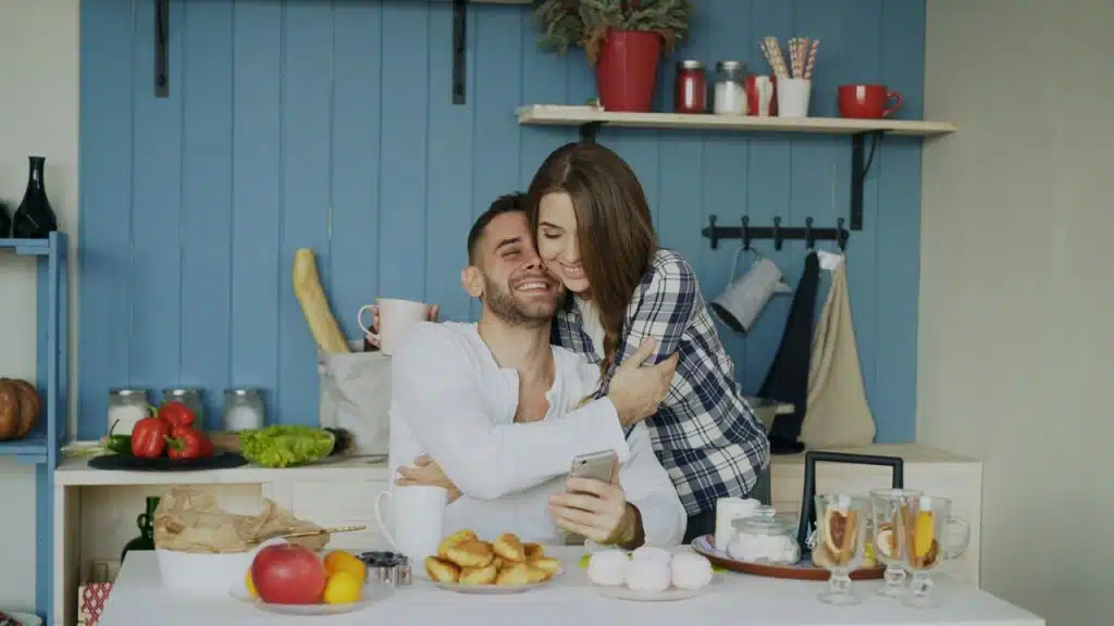 A couple hugging in the kitchen