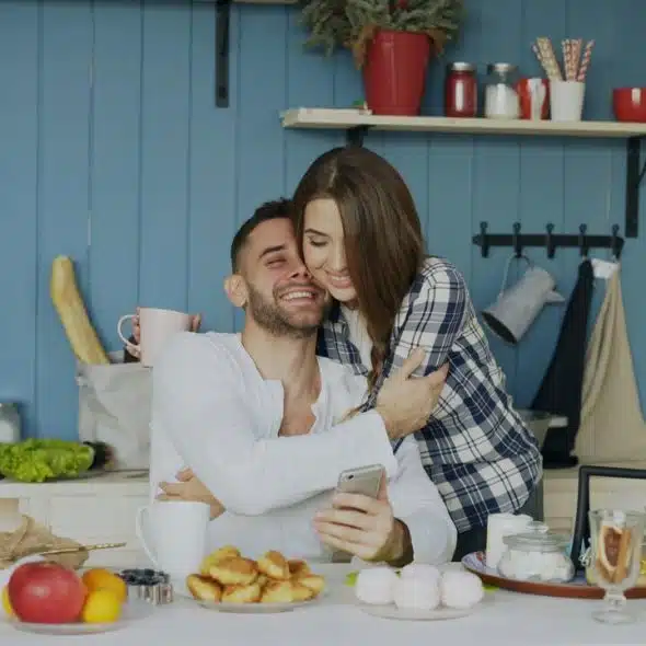 A couple hugging in the kitchen