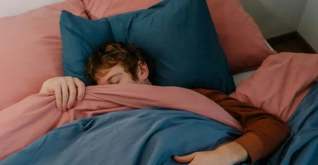 man snoring in bed