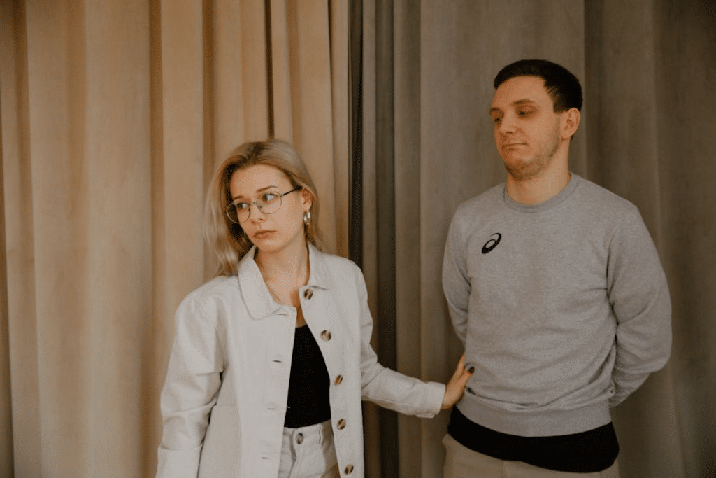 Man Standing Beside Woman Feeling Disappointed