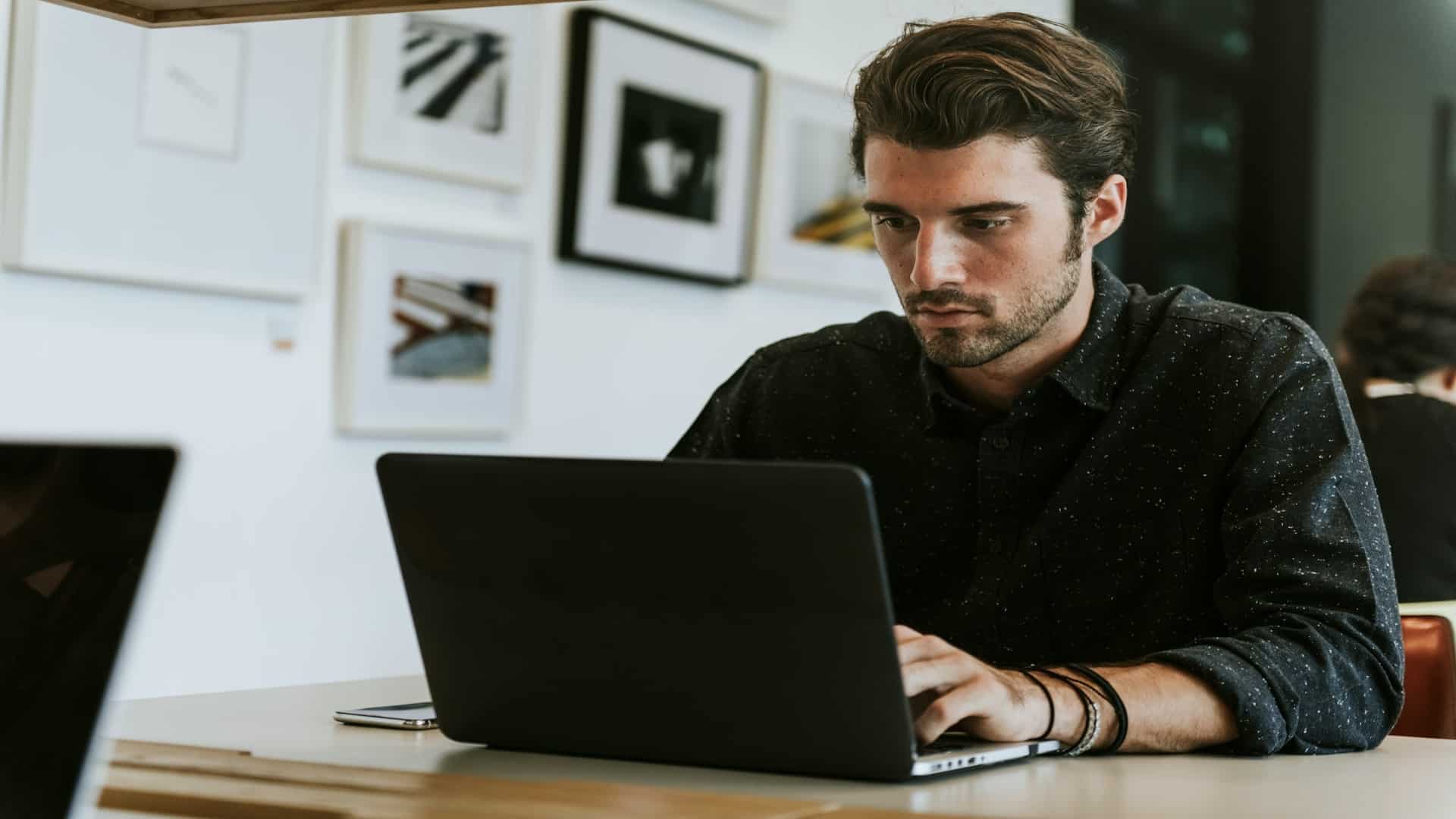 man focused on laptop