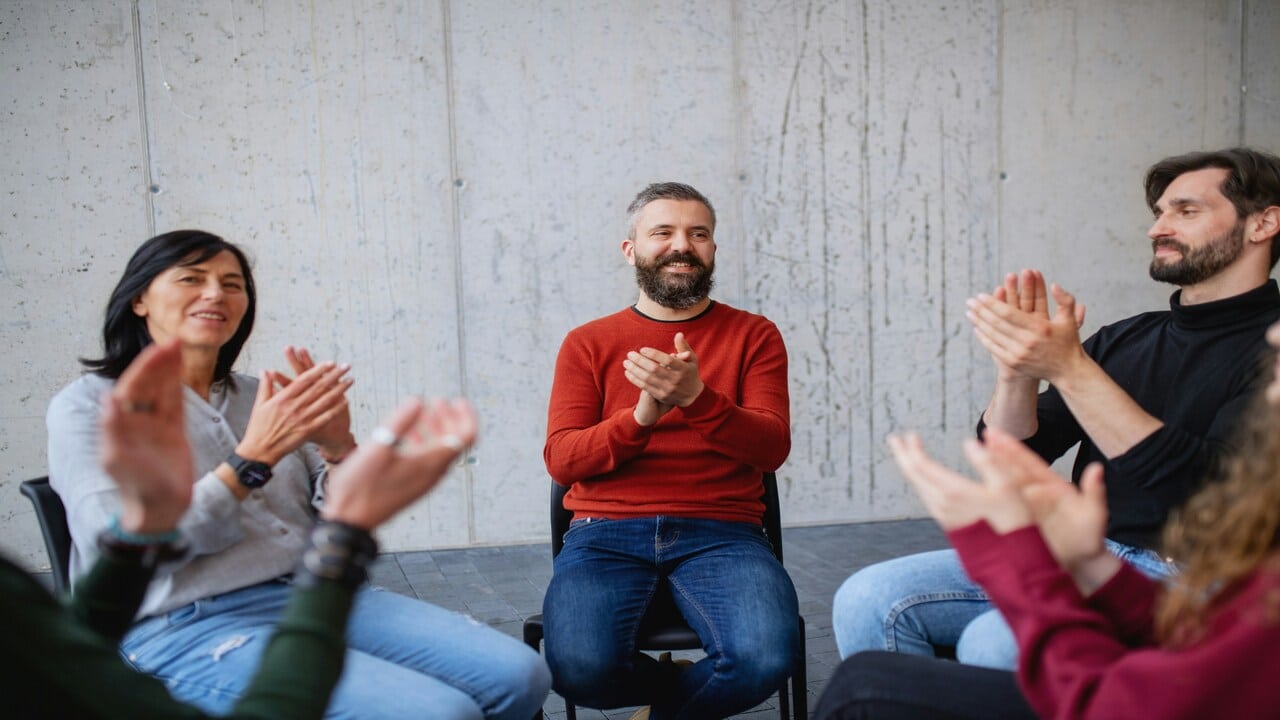 A group of people clapping