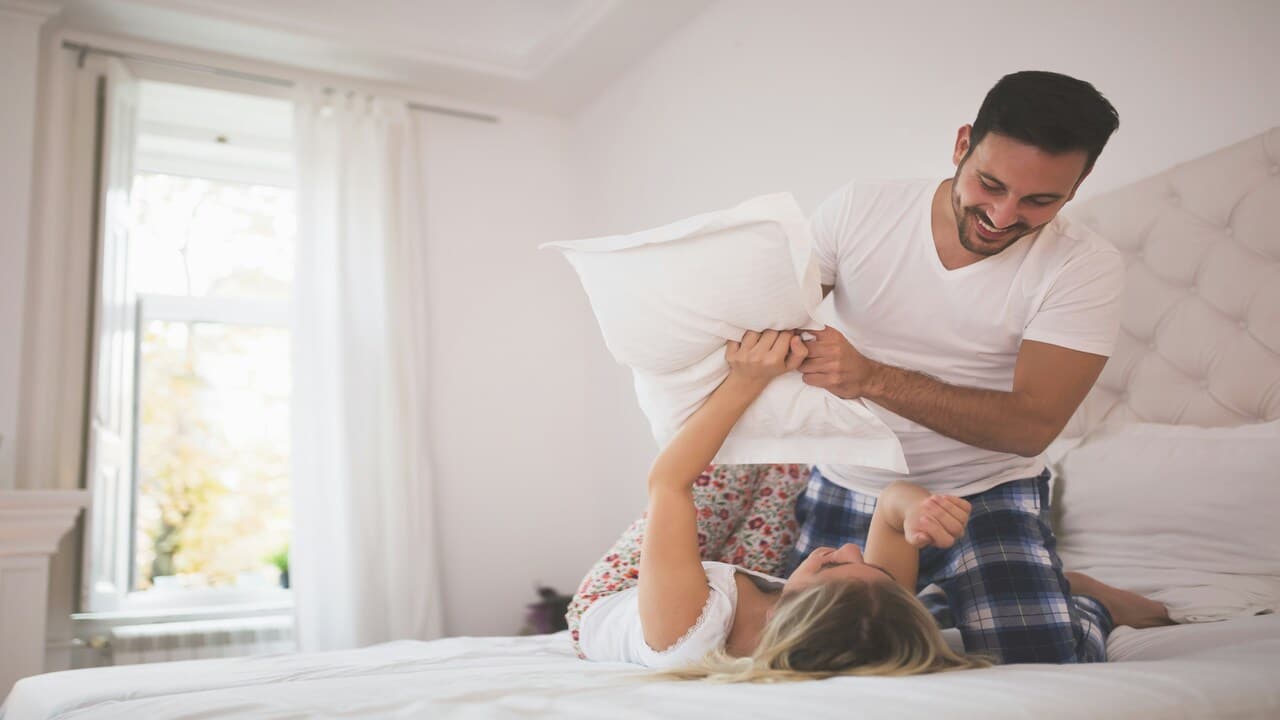 A couple having a pillow fight