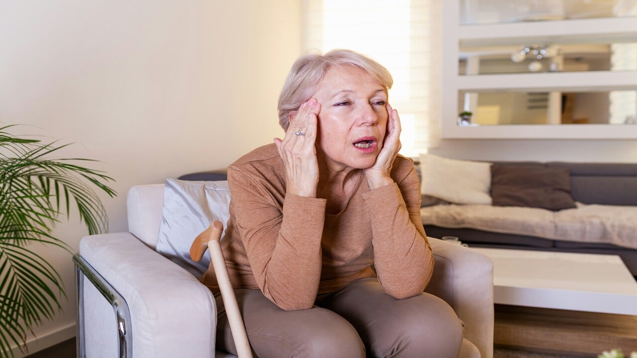 An elderly woman looking stressed