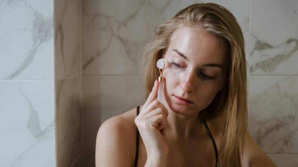 A woman using a facial roller