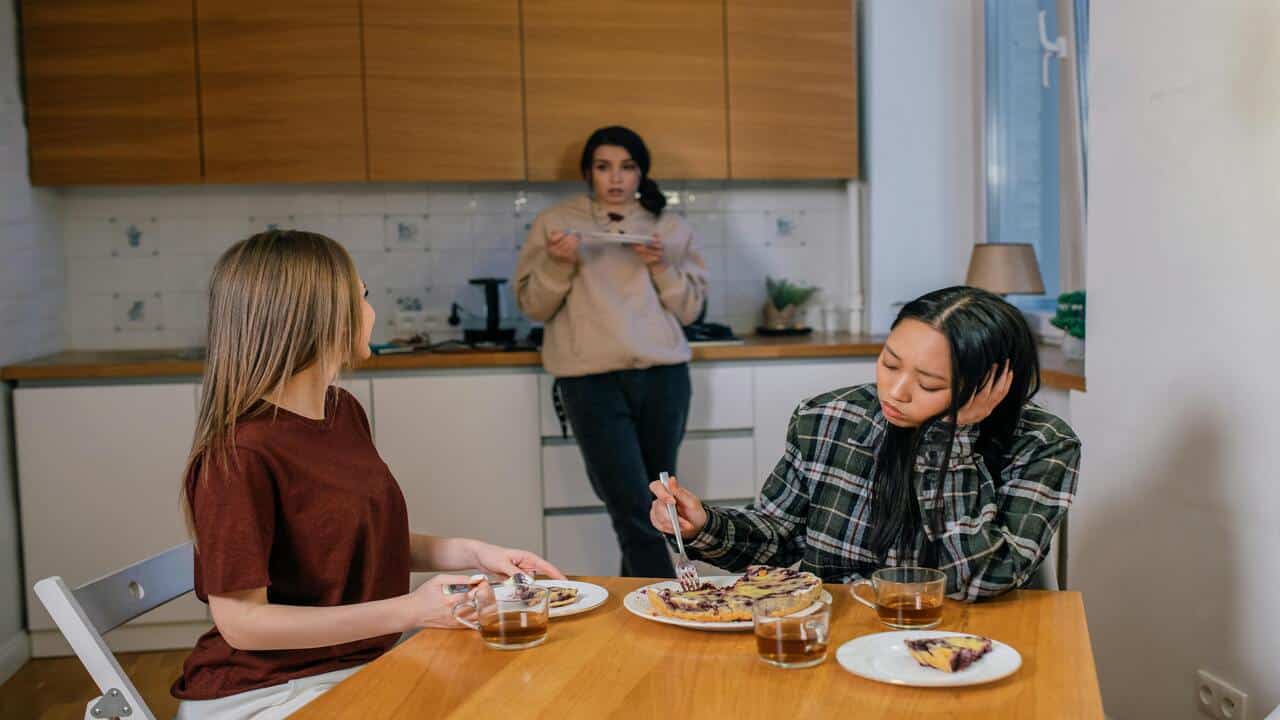 Friends having a serious talk at the kitchen table