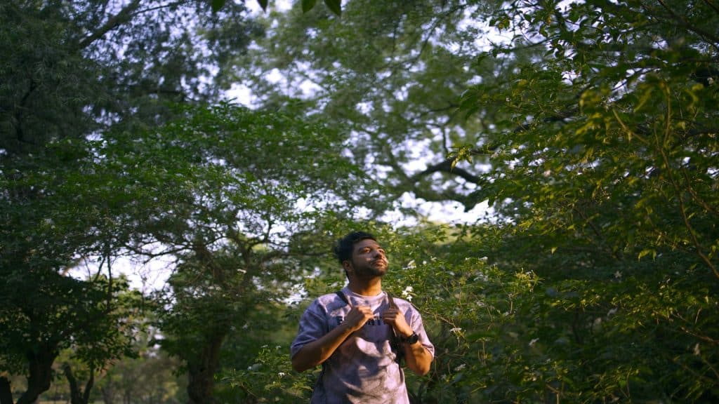 man standing confidently outdoors